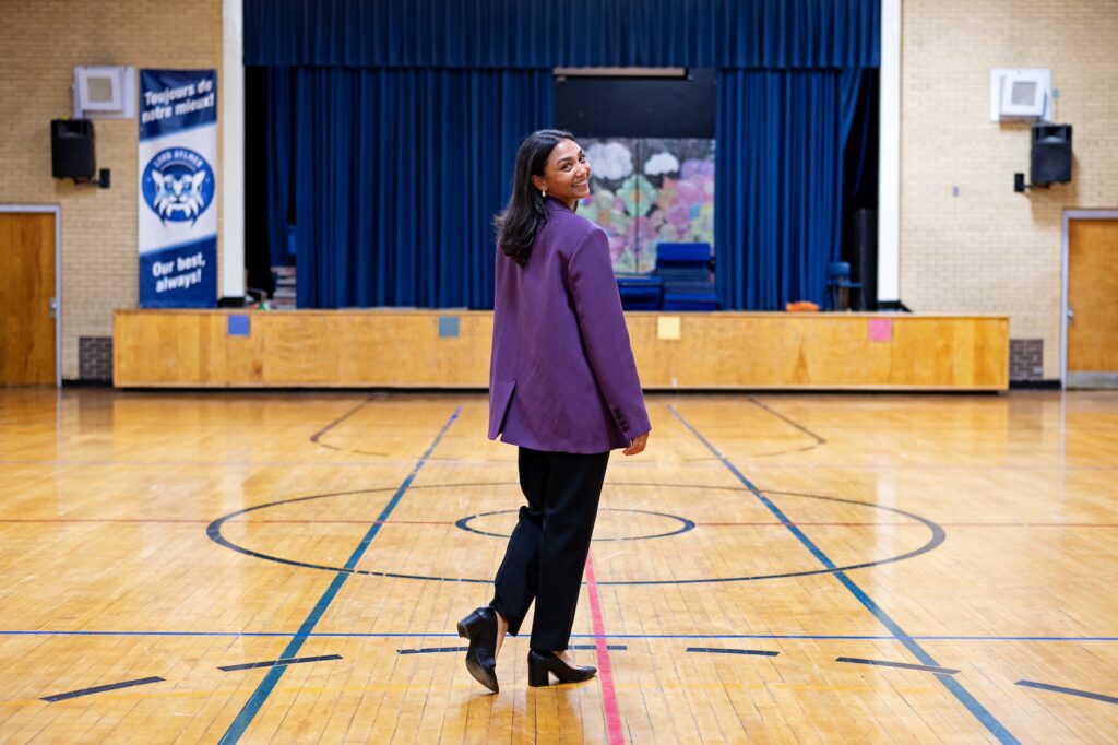 VP Patrick posing in the Lord Aylmer senior campus gym. // Mme Patrick pose dans le gymnase du campus sénior.