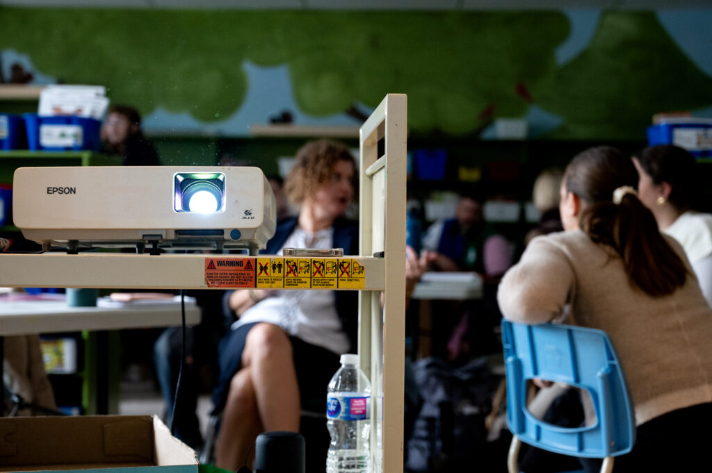 projector with teachers in the background