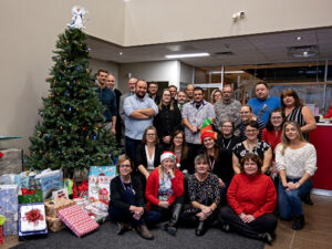 Members of the school board standing by the Angel Tree