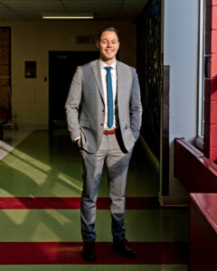 Jeremy standing by a sunny window in the cafeteria