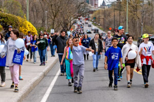 A long line of people participating in the Autism Walk as they go up Alexandre-Taché
