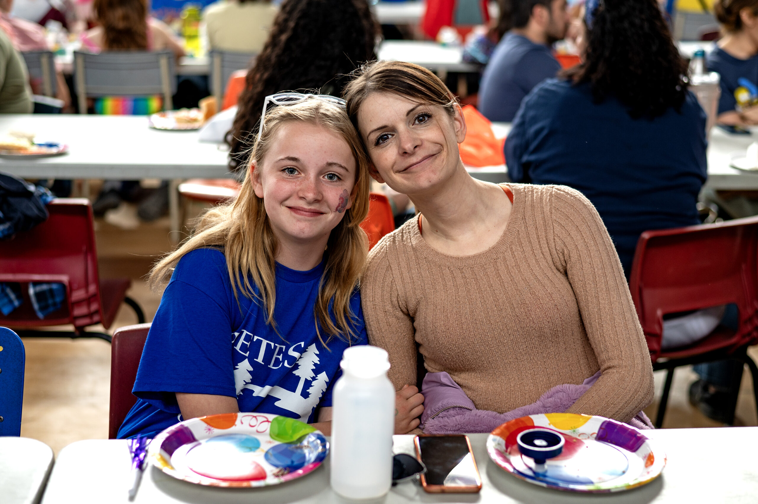 A mother-daughter volunteering duo pose for a photo together