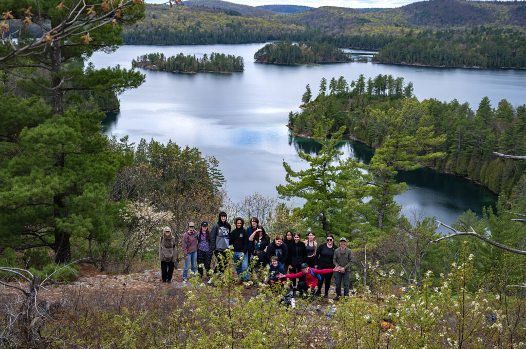 Group photo from atop a mountain with Green Lake in the background