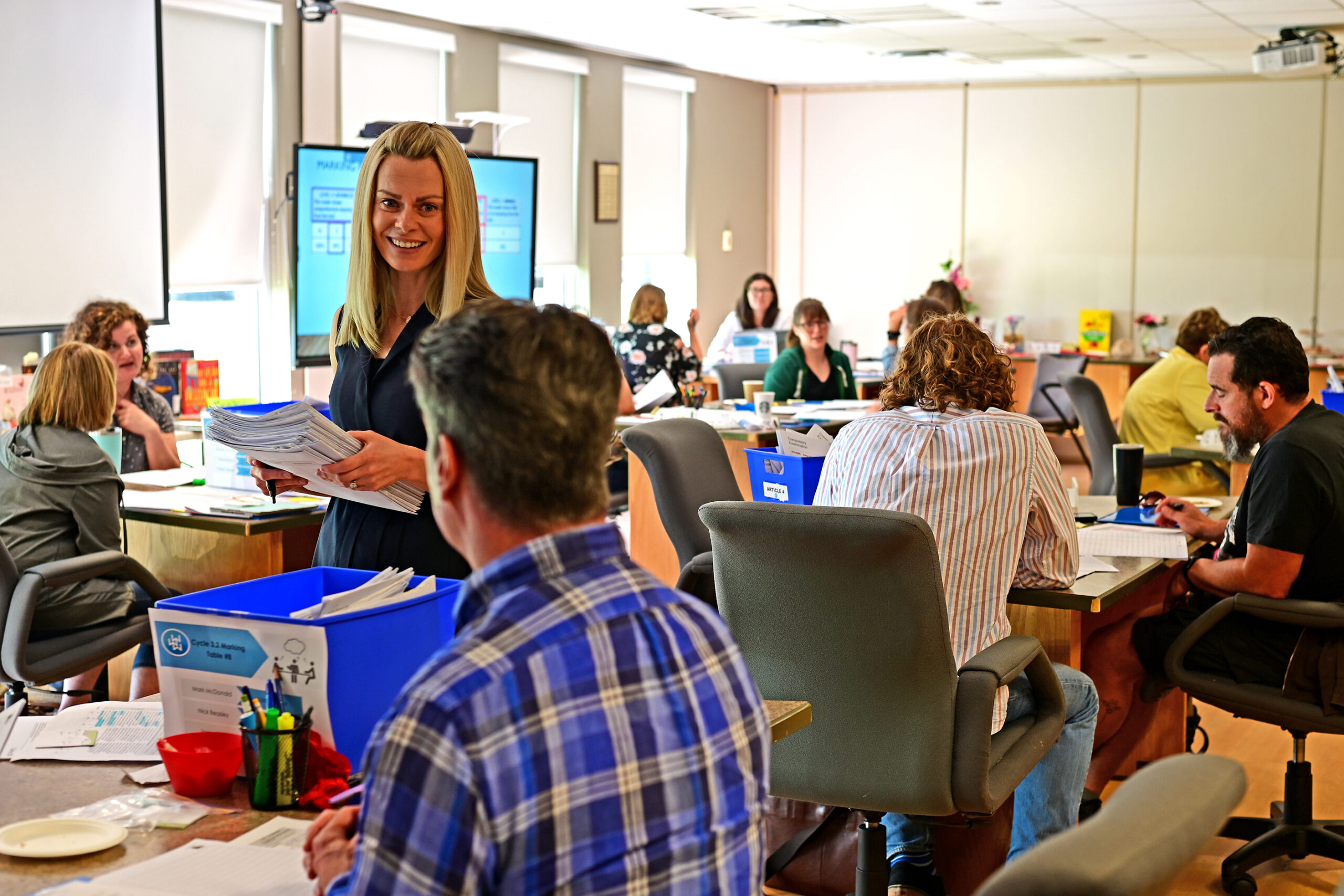 ELA consultant Sarah Kobia collects graded exams